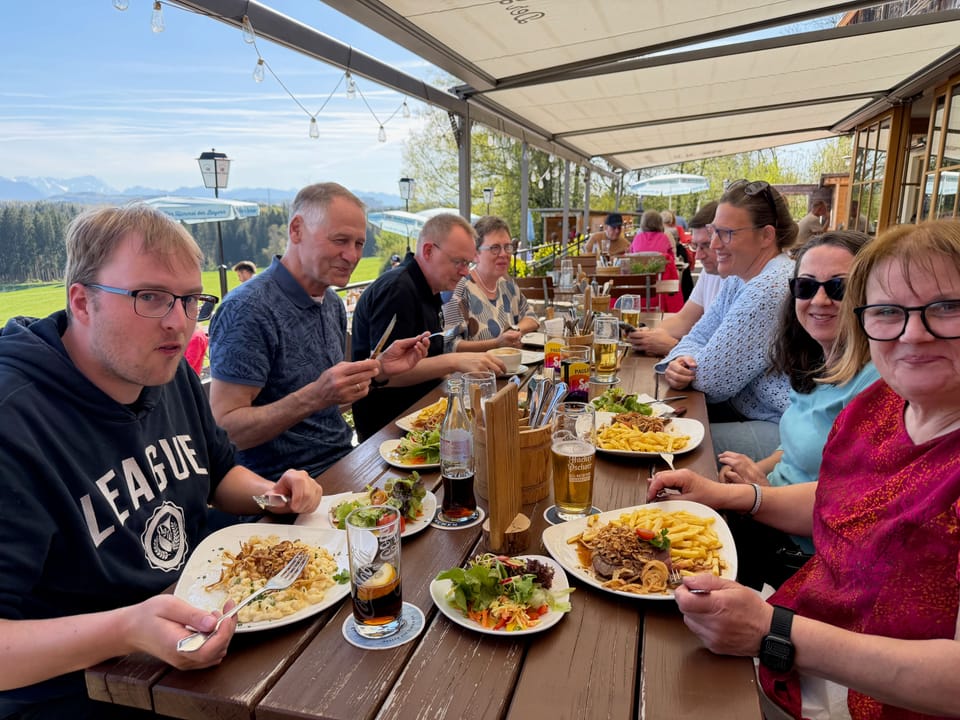 Lange Tafel auf der Terrasse, die Gruppe im Gespräch